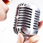 14770966-woman-holding-big-retro-microphone-for-singing-Stock-Photo-microphone-singer-karaoke