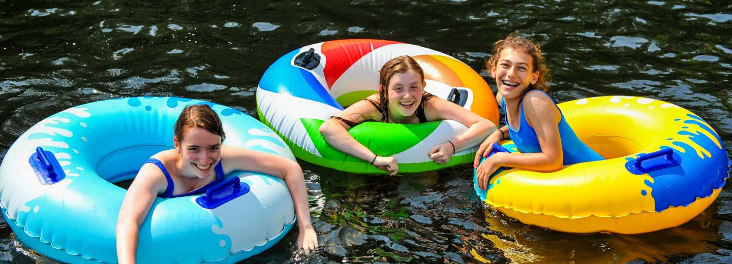 Campers on innertubes in lake