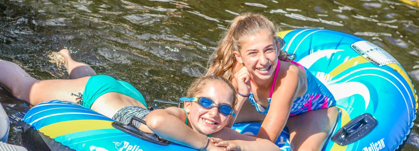 Girls on lake with inflatable rafts