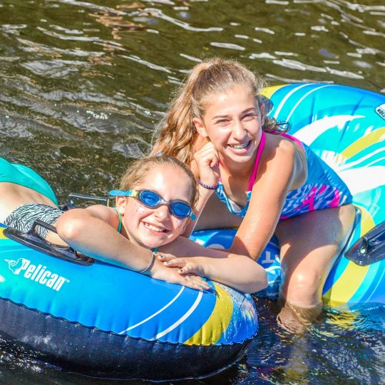 Girls on lake with inflatable rafts